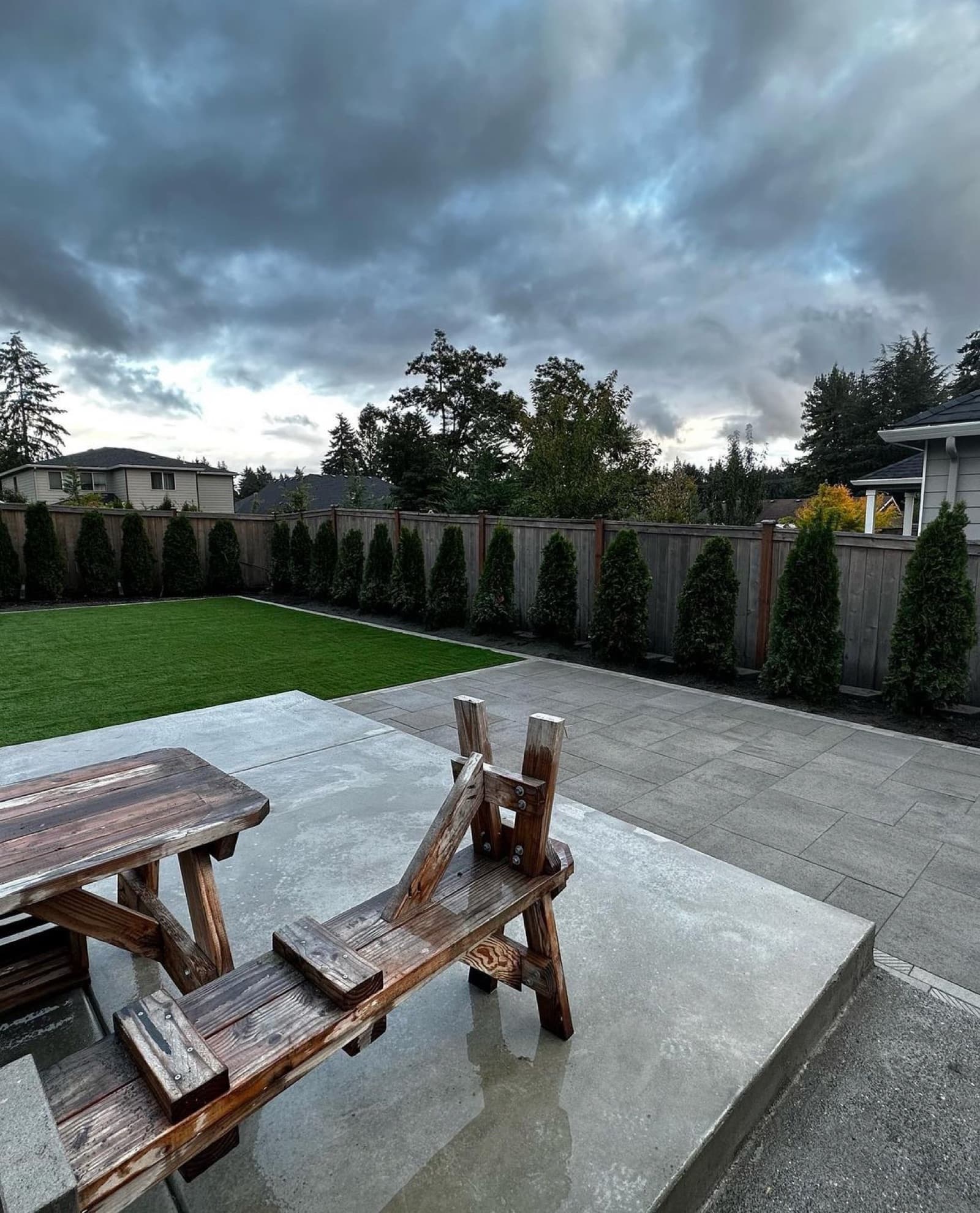 Circular paver patio design with center fire pit pad