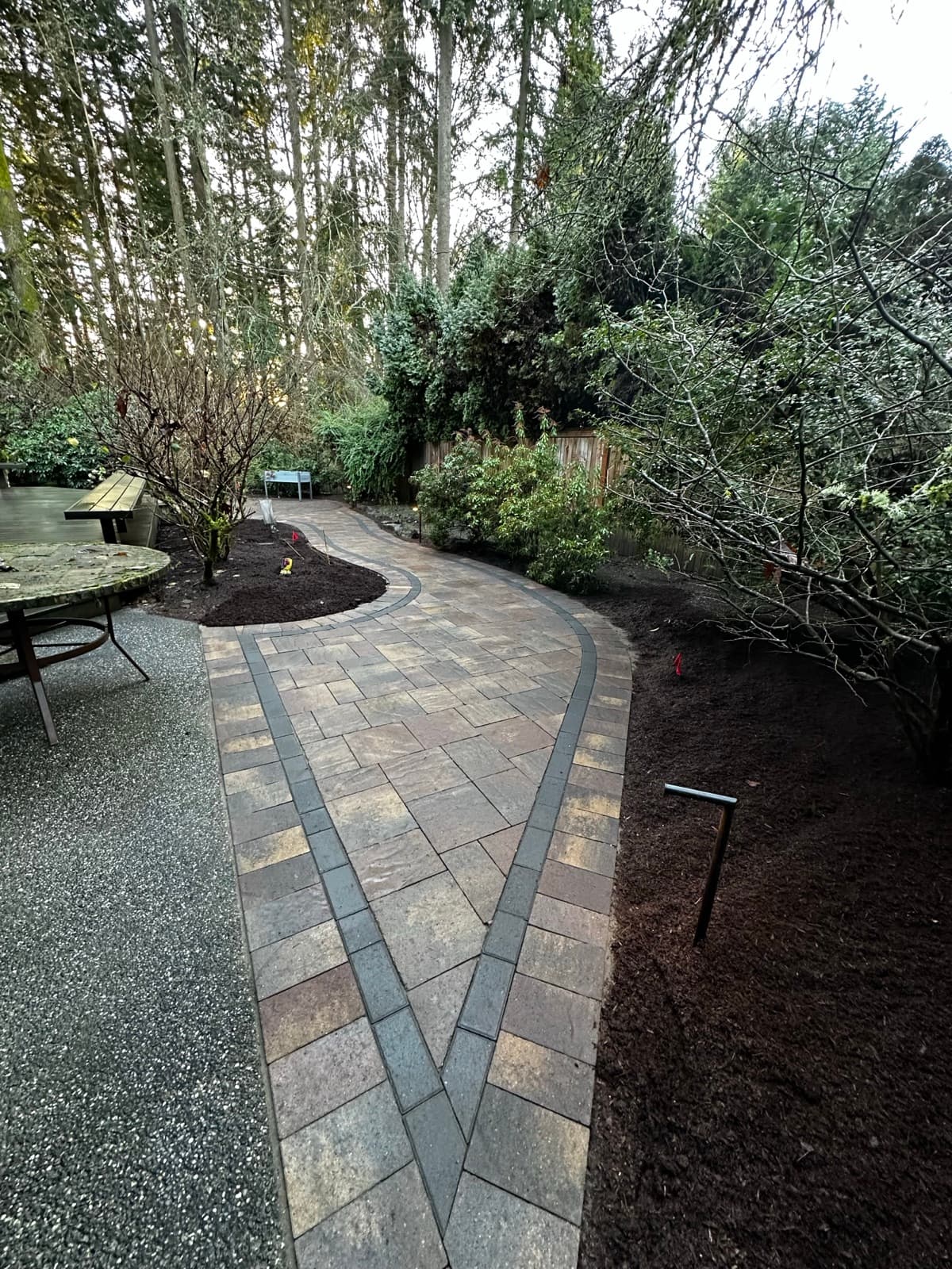 Paver patio with pergola foundation and landscape integration