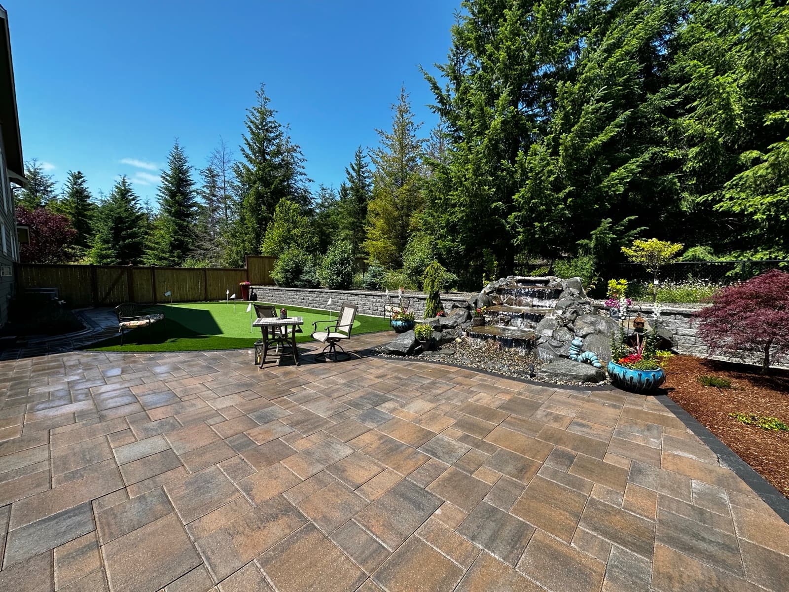Backyard paver installation with lawn transition