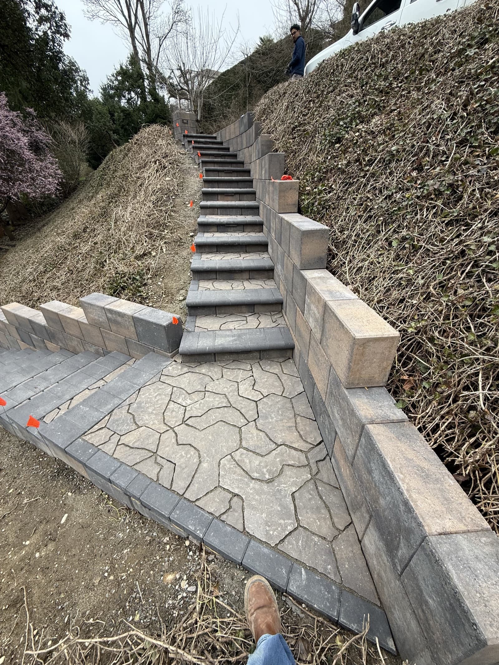 Retaining wall and steps mid-build with utility flags