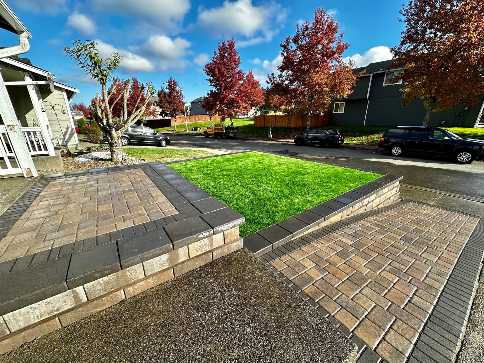 Tiered stone retaining wall with plantings on hillside property
