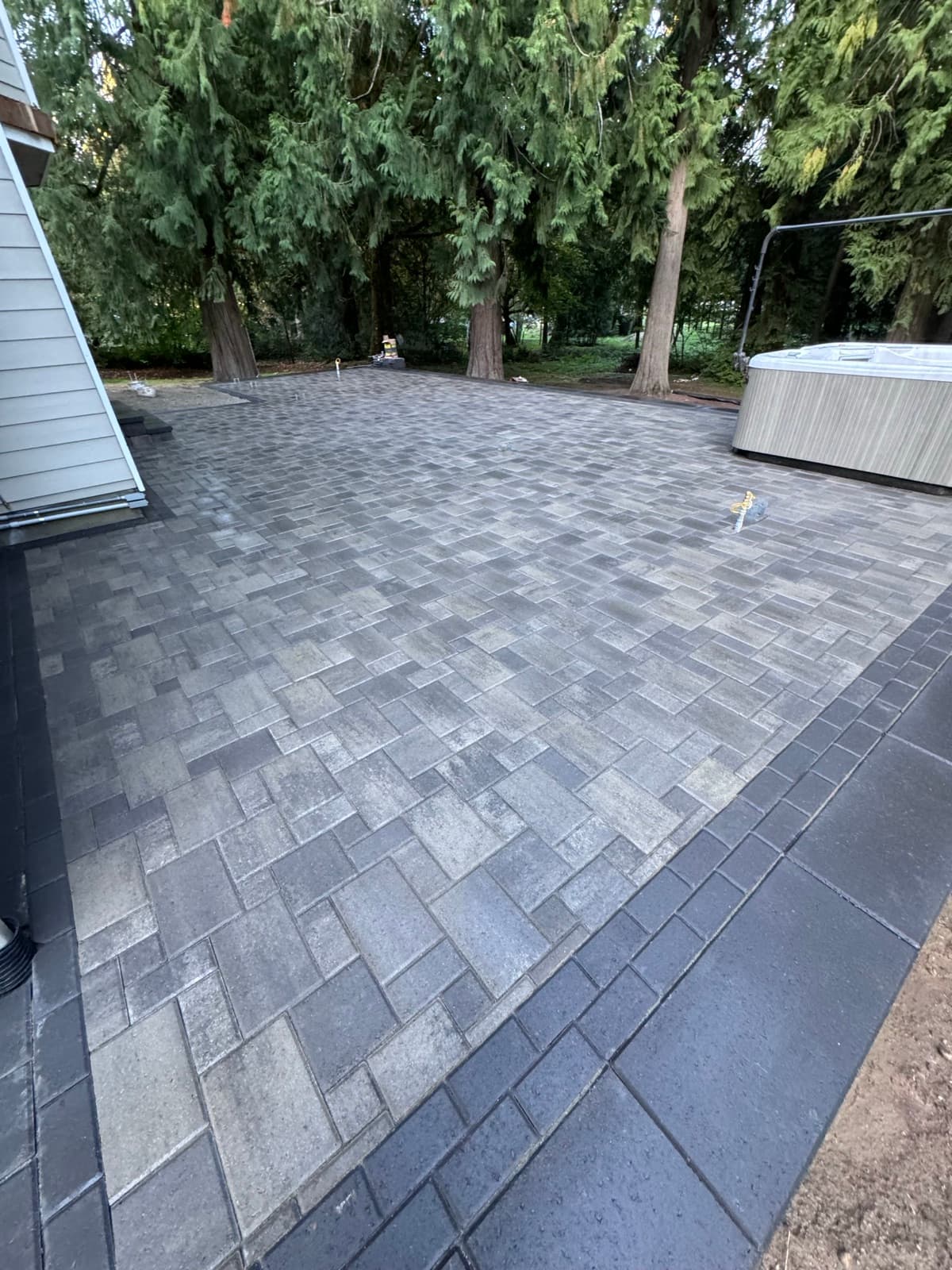 Curved paver walkway through landscaped front yard