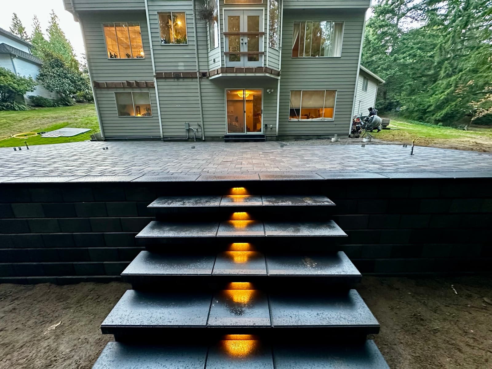 Paver pathway connecting patio to garden area
