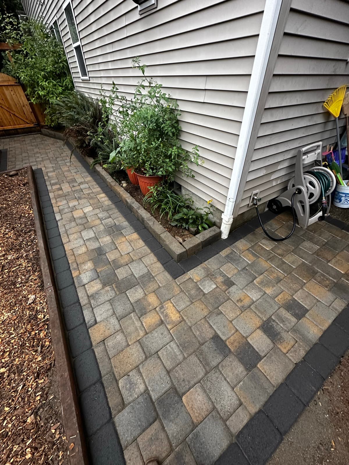 Stone walkway with border pavers and landscape lighting