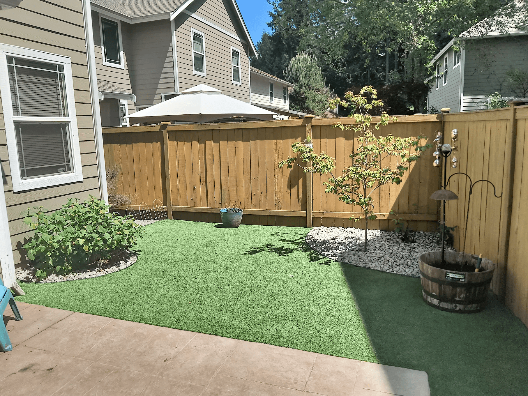 Finished artificial turf installation in a compact backyard