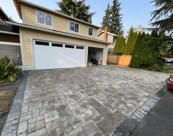 Completed gray paver driveway installed by ND Brick Pavers at the same home